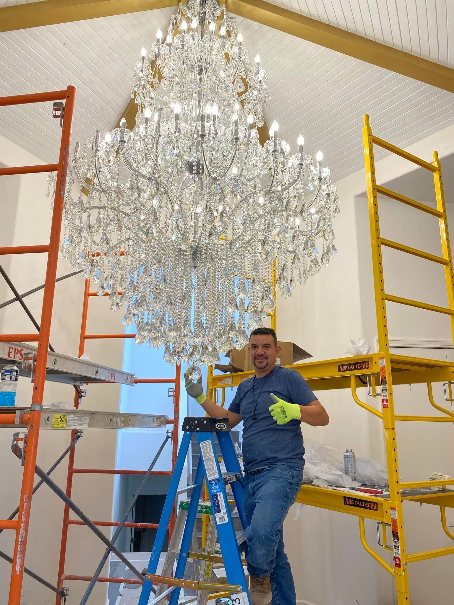 JEVAS Innovations craftsman installing a chandelier during a home remodel in El Paso, Texas